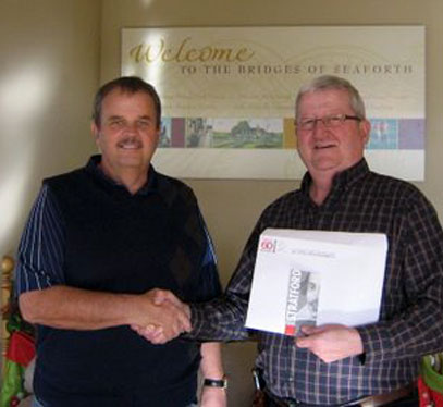 Bill MacLean (on left) from the Bridges presenting the Straford Festival Gift Certificate to Ed Scarlett